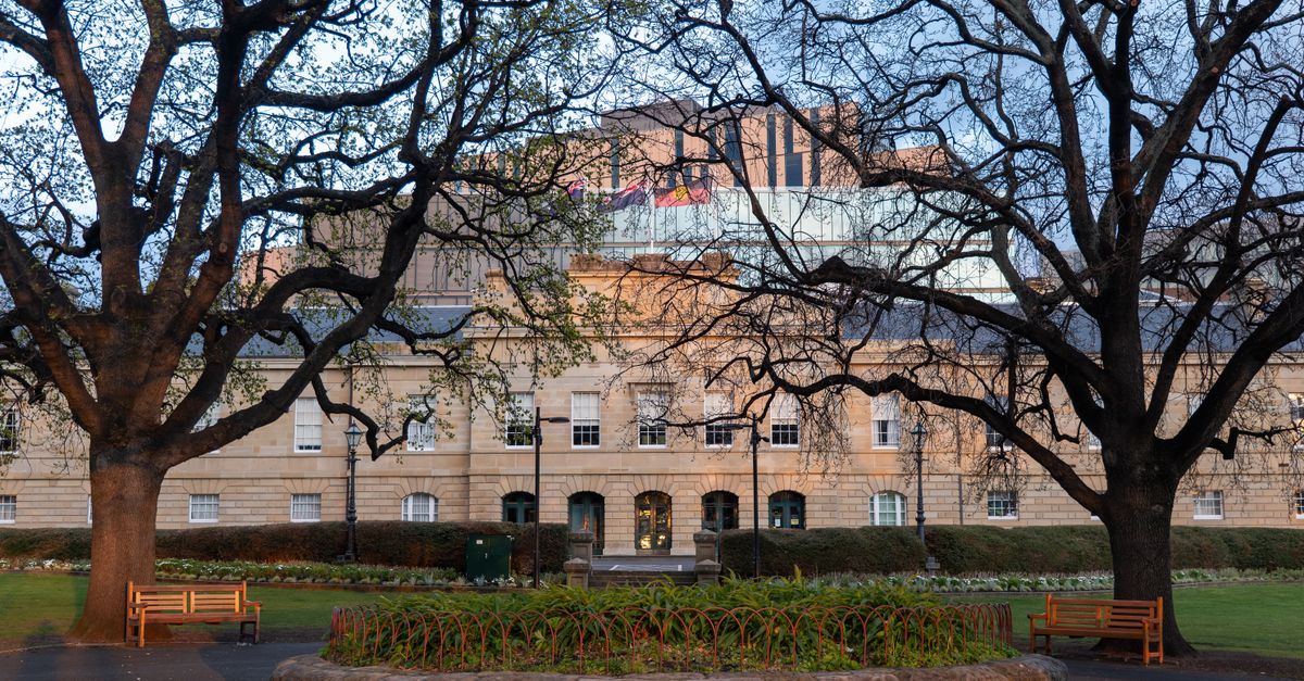 Historic Hobart Courthouse framed by trees in early morning light, Tasmania.