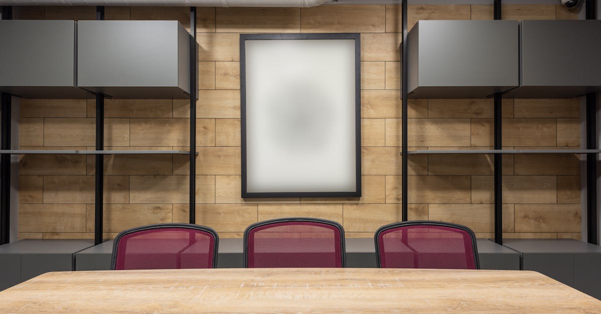Contemporary interior of new boardroom equipped with wooden table and red office chairs