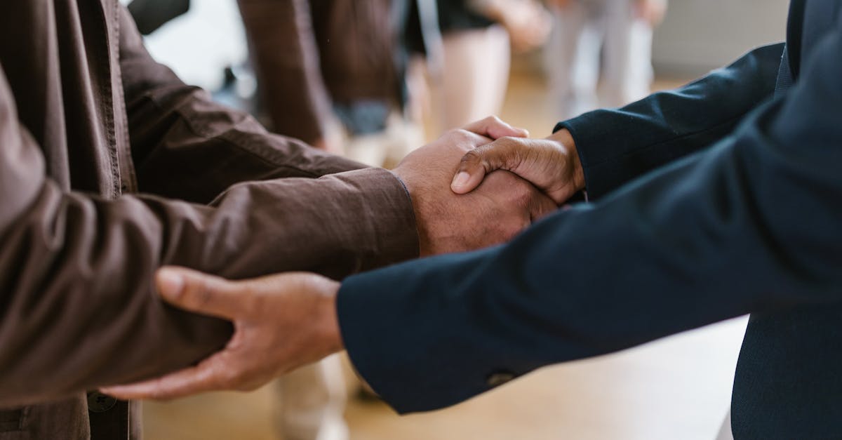 Close-up of two businesspeople shaking hands, symbolizing agreement and partnership.