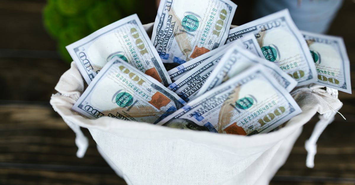 A top view of a sack brimming with US 100 dollar bills, symbolizing wealth and prosperity.