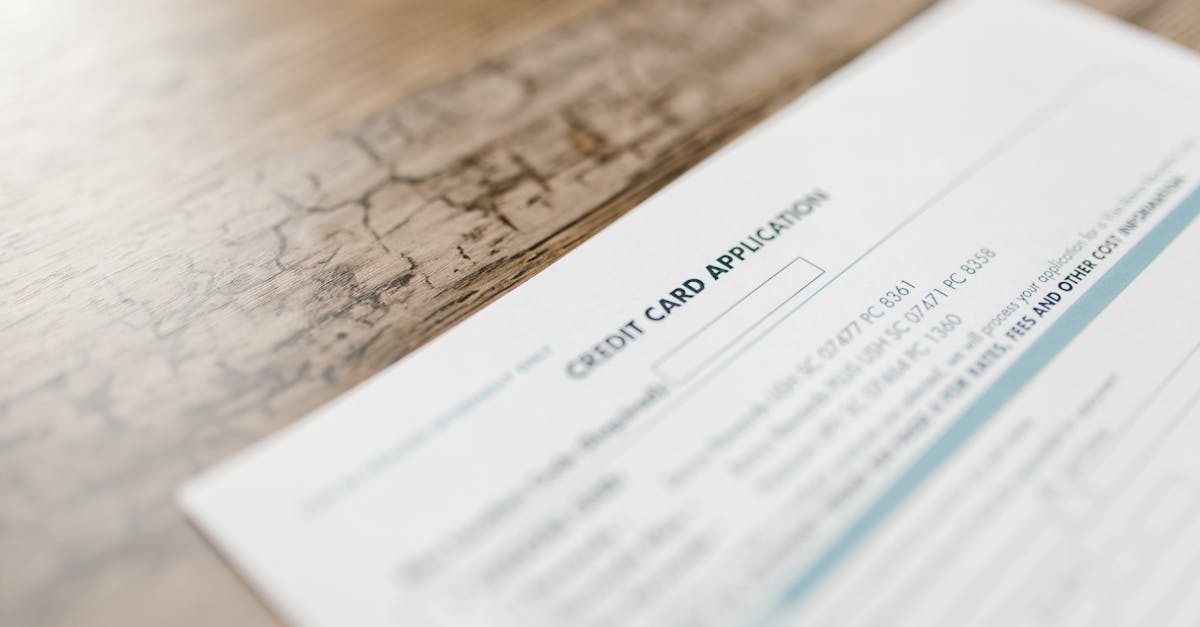 A credit card application on a wooden desk, depicting finance and banking tasks.