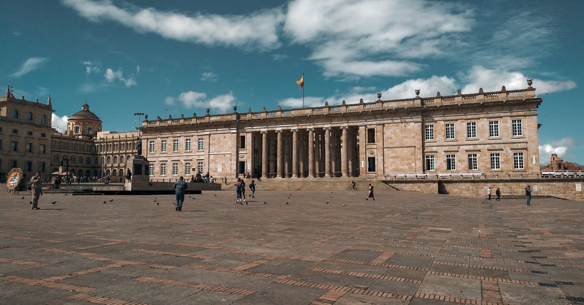 Glimpse the grand facade of Bolívar Square in Bogotá under a bright blue sky.