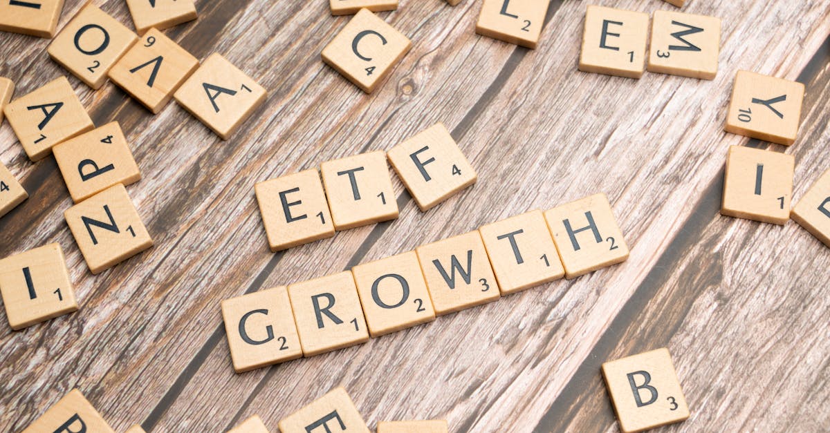 Wooden tiles spelling ETF growth on a wooden surface, symbolizing investment strategy.