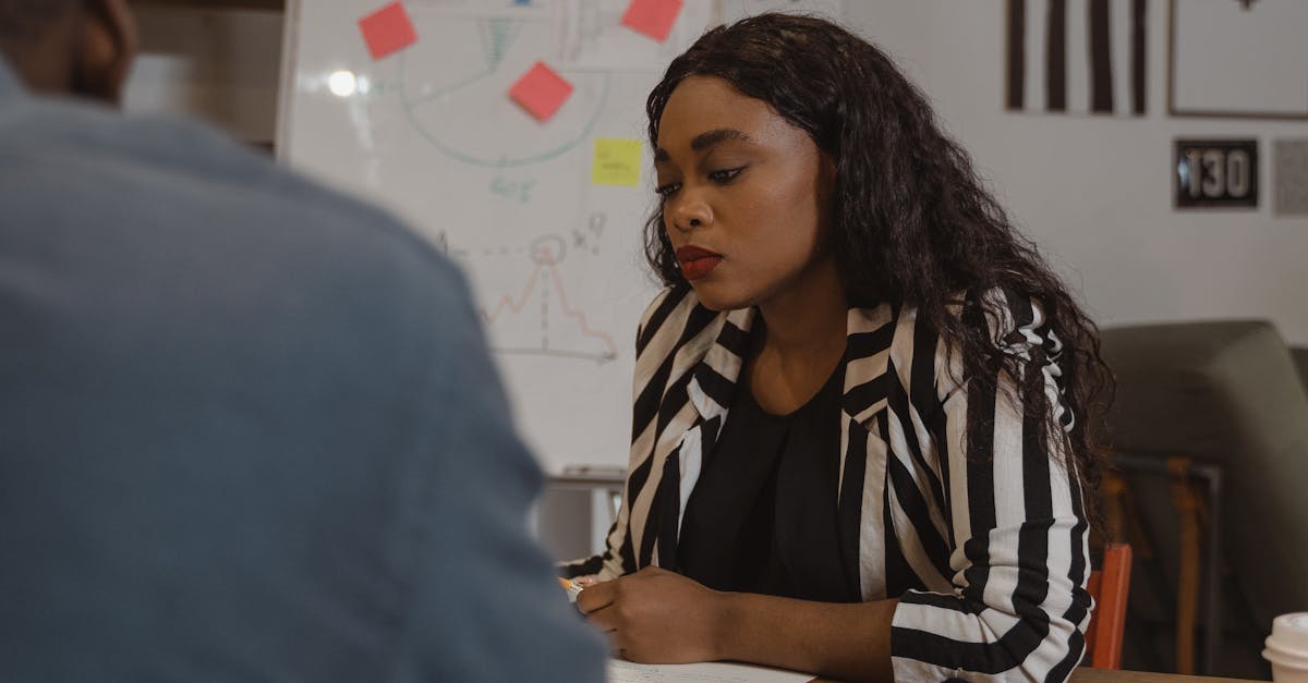 Focused professional woman in a meeting with a colleague at work.
