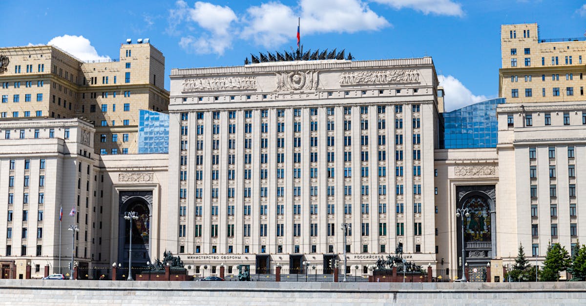 Facade of the Russian Ministry building in Moscow along the river under a clear sky.