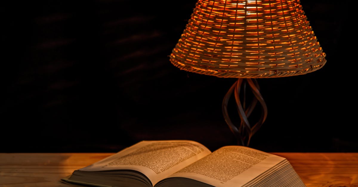 A cozy scene of a book under a woven lamp, perfect for late-night reading in a warm atmosphere.