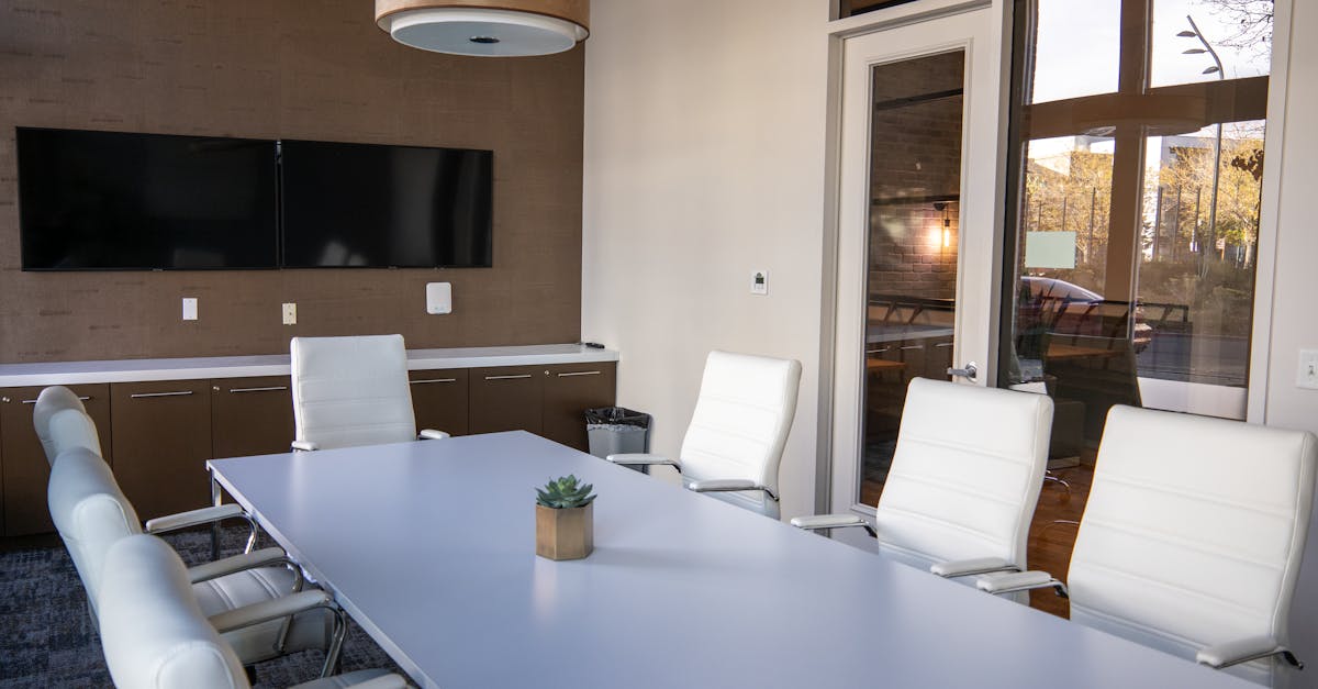 Spacious and modern conference room with sleek furniture and natural lighting.