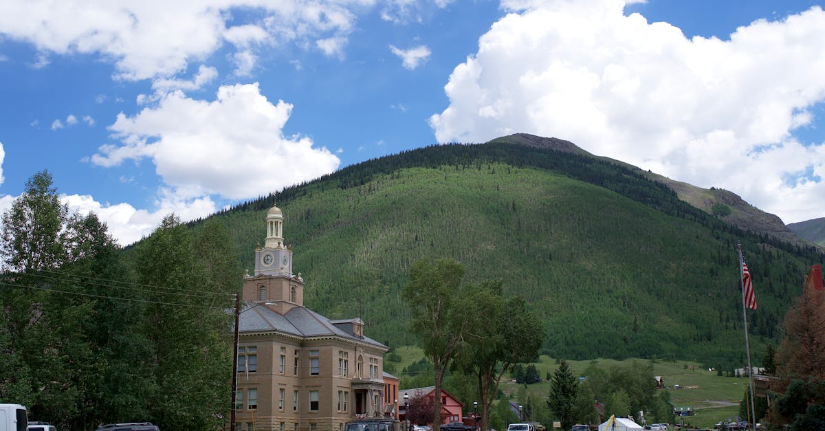 Scenic view of the San Juan County Courthouse with mountainous backdrop in Silverton, Colorado.