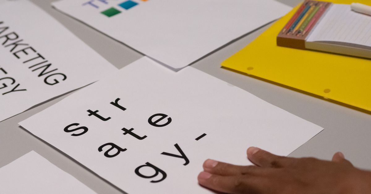 Close-up of marketing strategy notes and colorful trends sheet on a table for planning session.