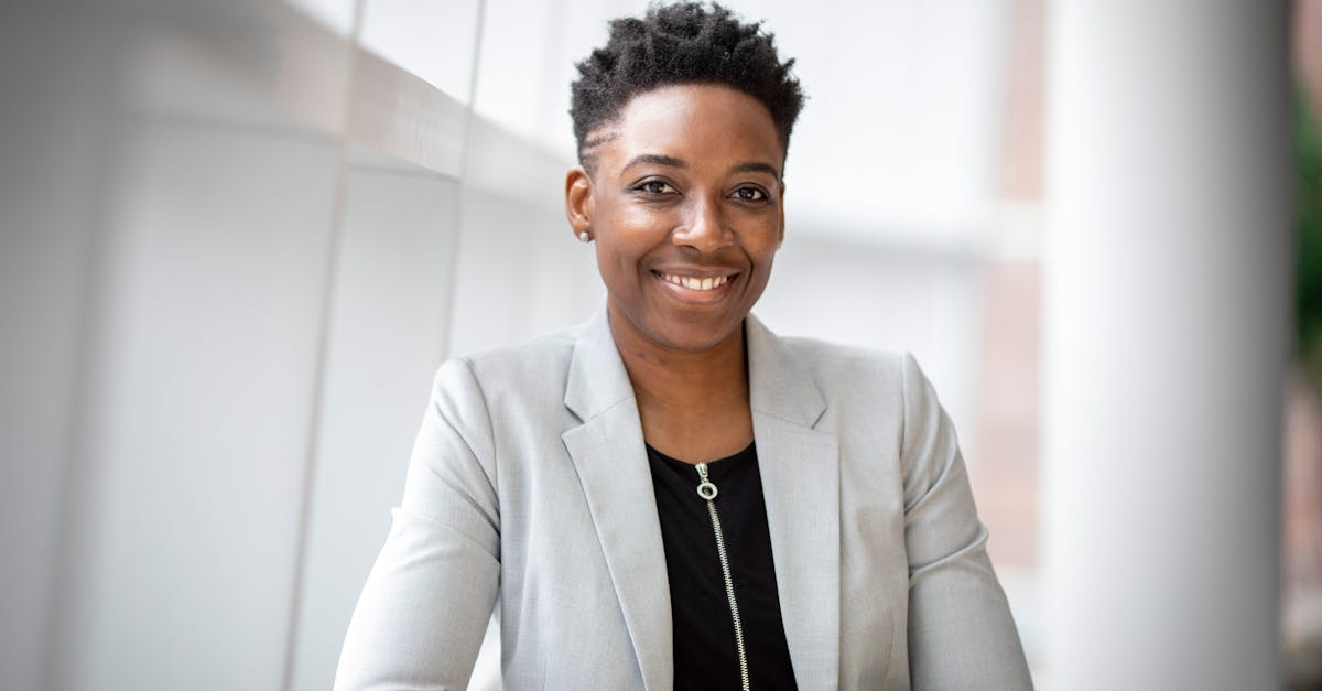 Confident African American businesswoman smiling inside a modern office space.