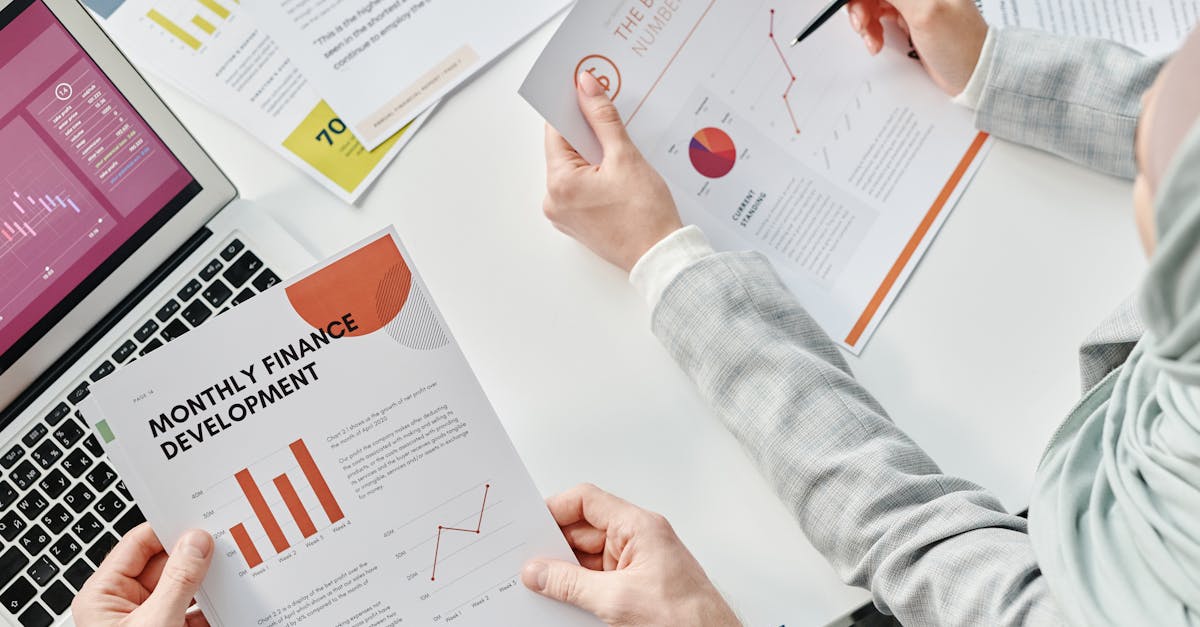Top view of business colleagues analyzing financial reports during a meeting at the office.