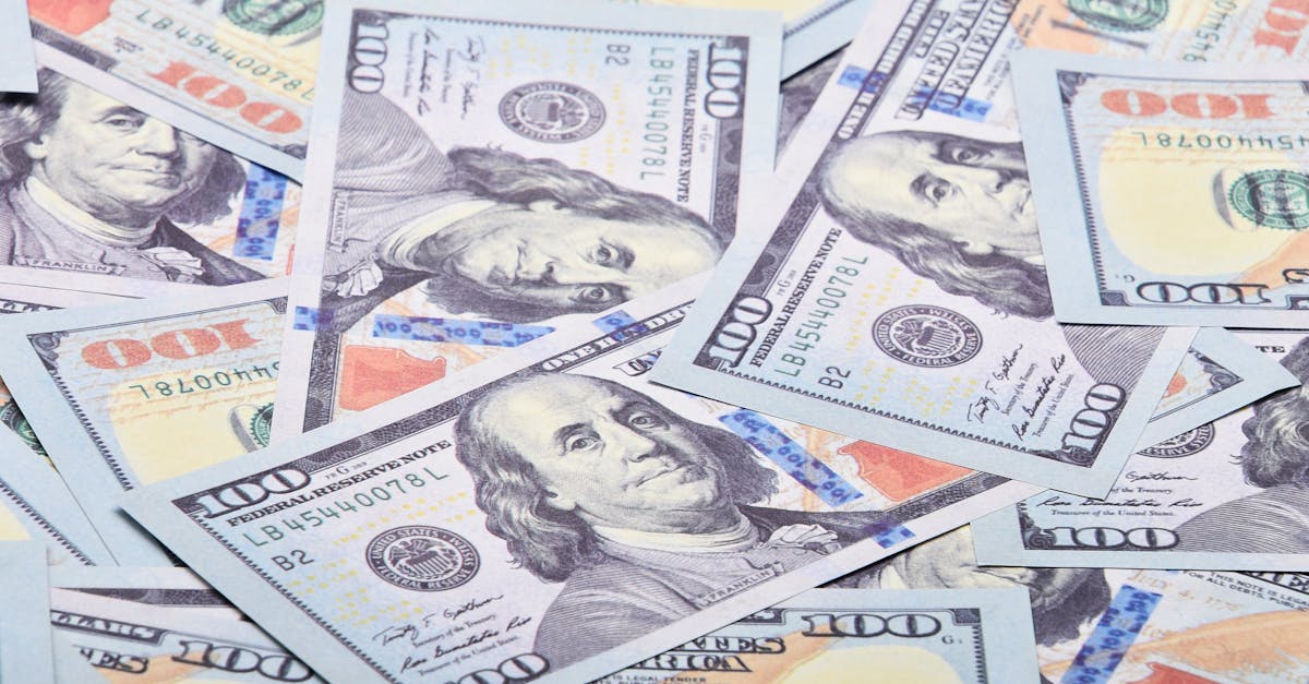 A detailed close-up shot of multiple US dollar bills spread out, showcasing currency detail.