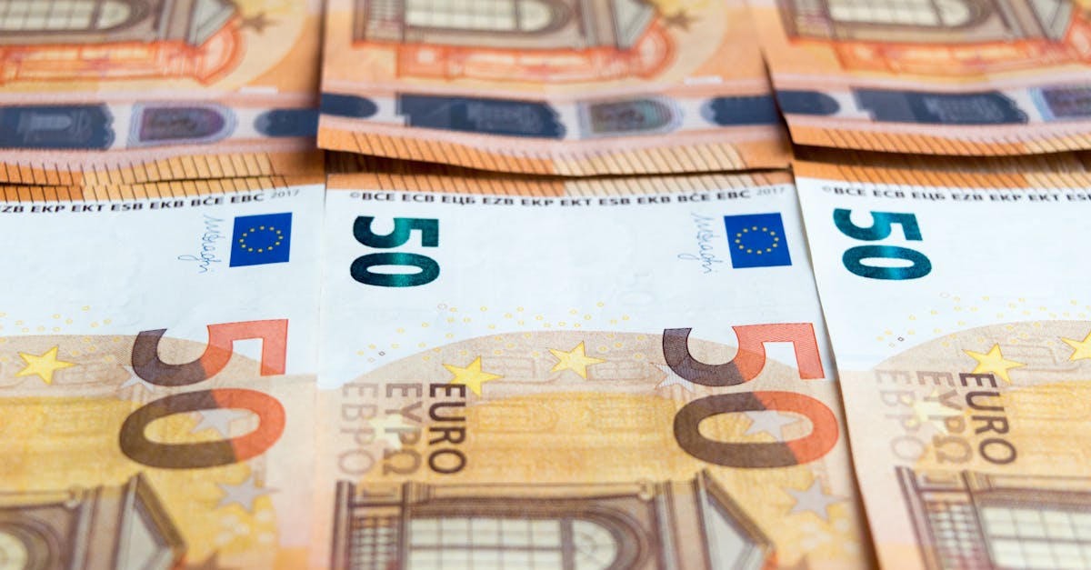 Detailed image of multiple 50 Euro bills stacked, showcasing currency design.