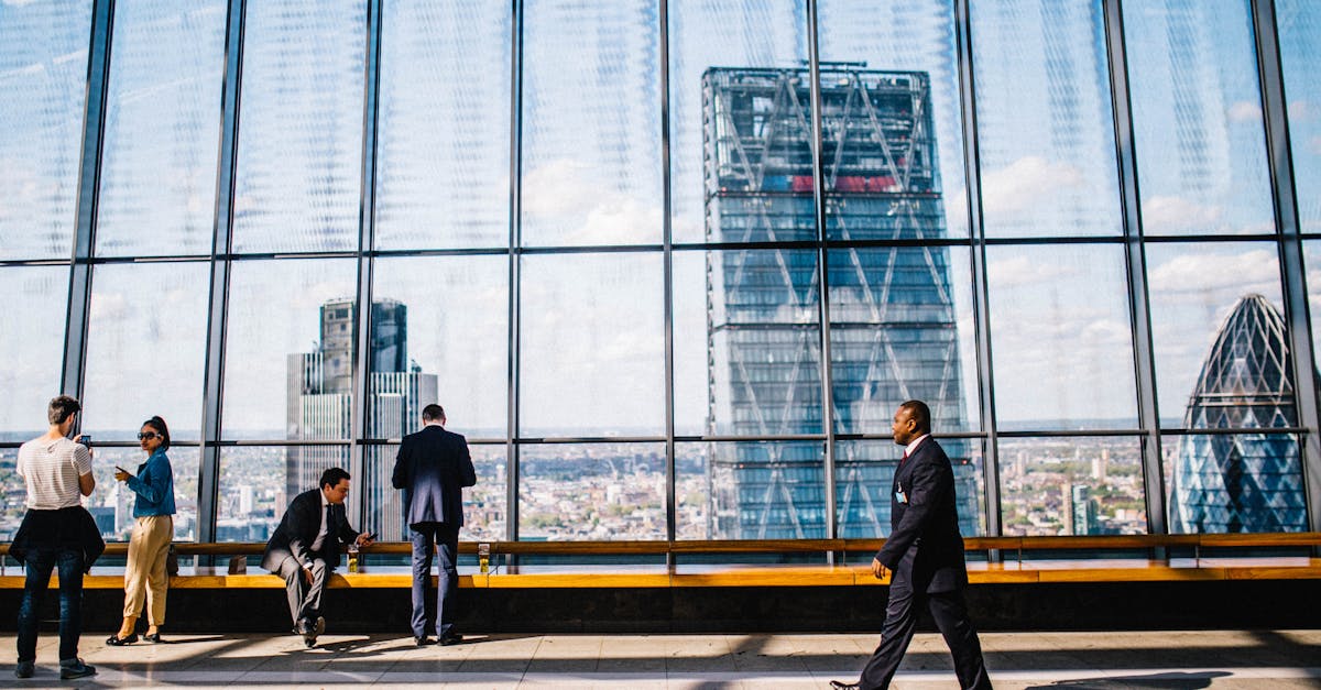 Business professionals in a modern office against a London skyline view.