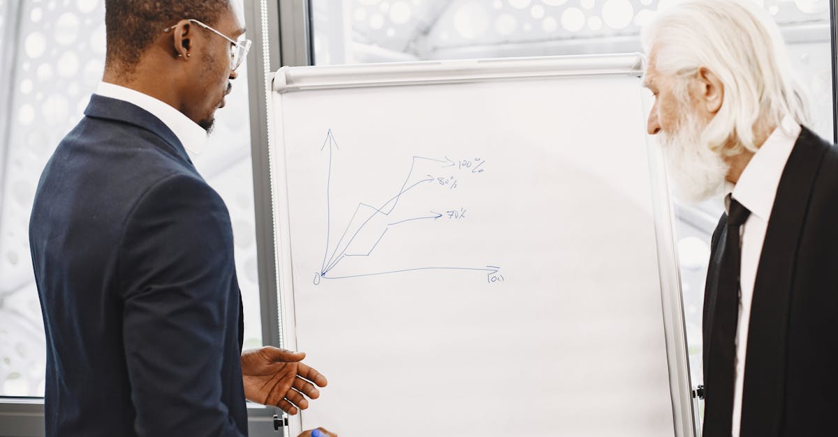 Two businessmen discussing financial charts at an office meeting.