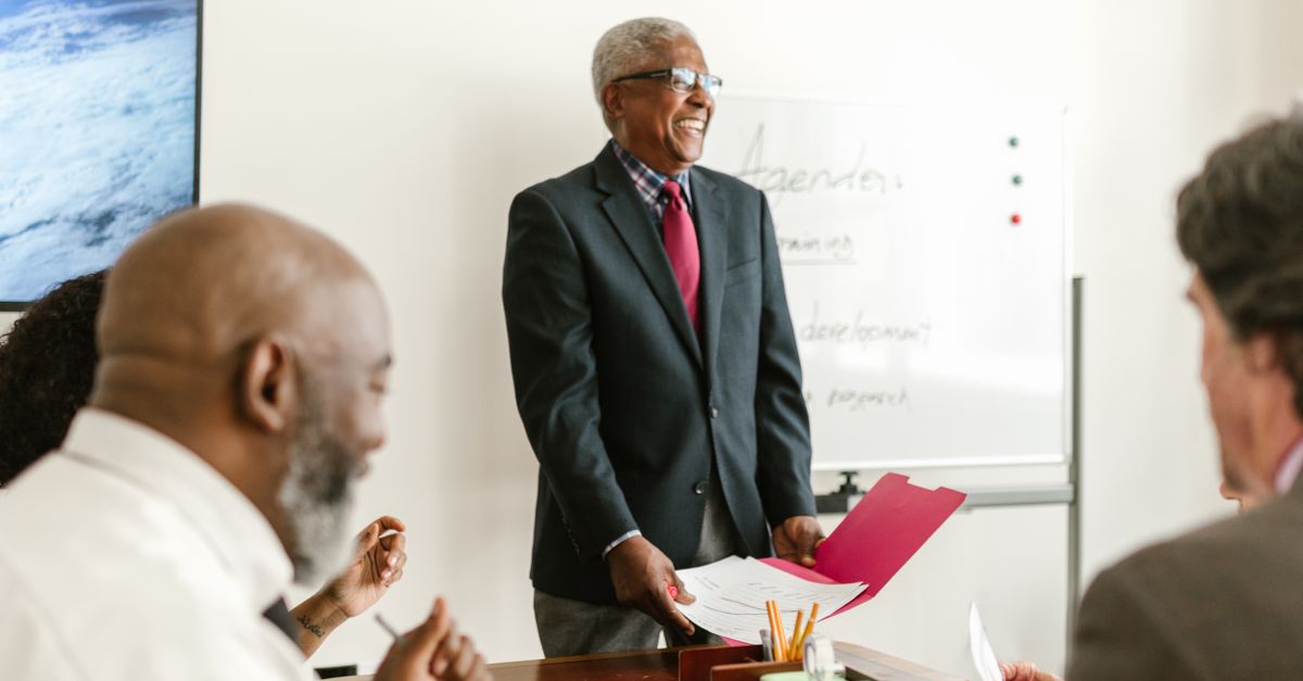 Professional meeting scene showcasing discussions and presentations in an office setting.