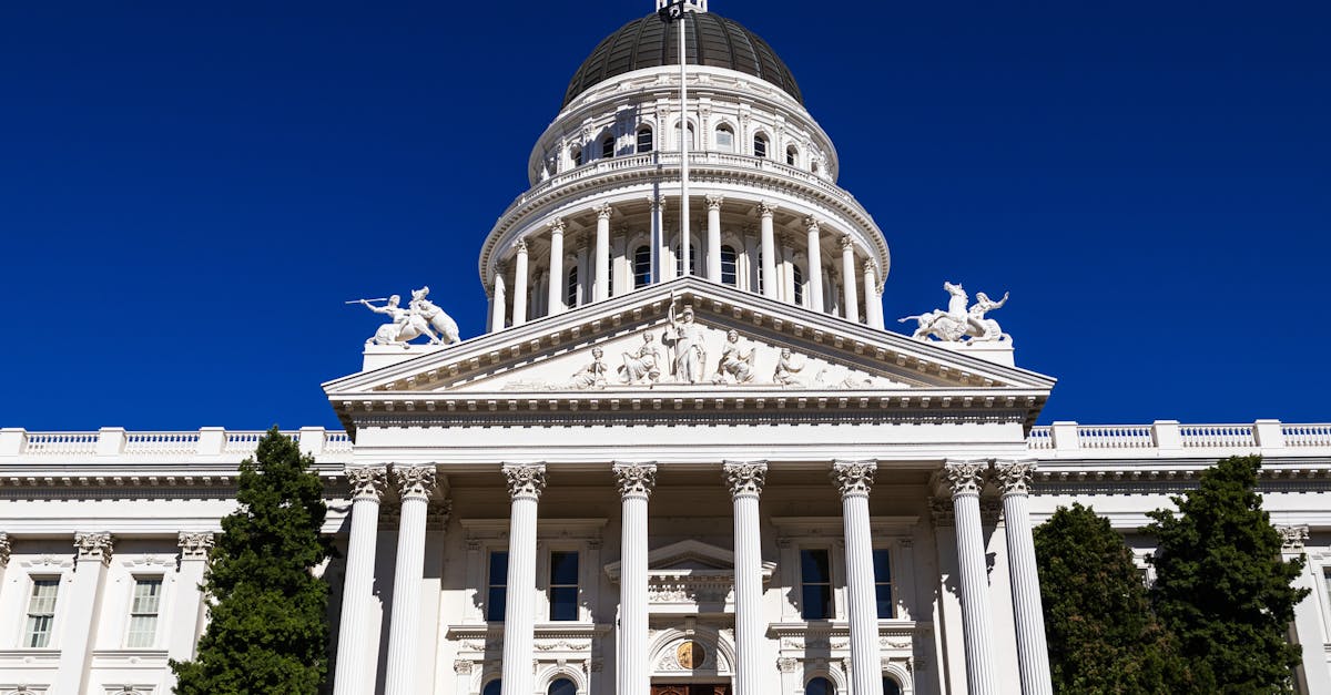 Sunlit view of the California State Capitol with clear blue skies.
