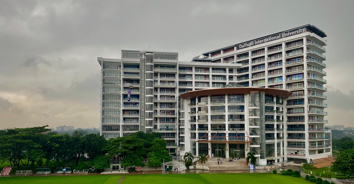 Modern architectural view of Daffodil International University with lush green surroundings in Dhaka.
