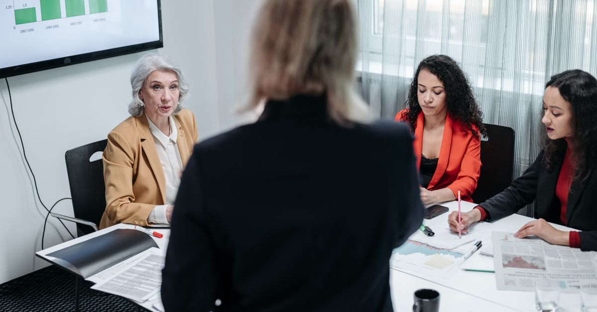 Team of professionals discussing strategy in a modern office setting during a business meeting.