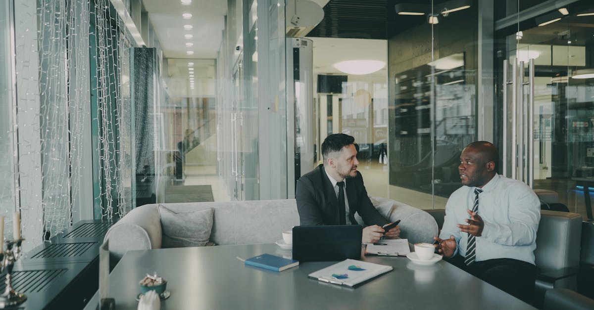 Two businessmen discussing strategy in a contemporary office environment.