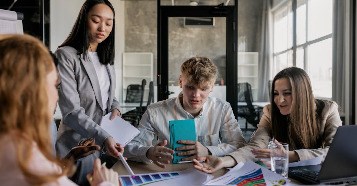 A diverse group of colleagues having a lively discussion around a conference table in a modern office.