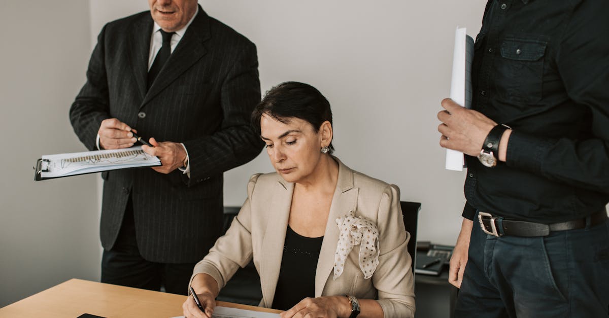 Business professionals collaborating on financial documents in an office setting.