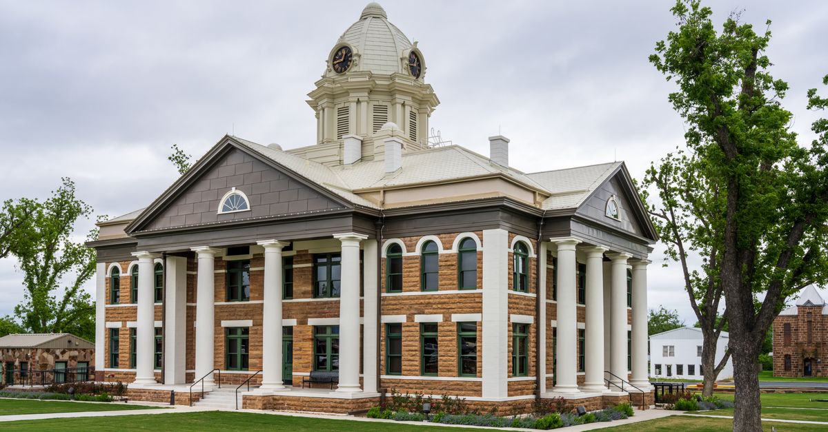 Elegant architecture of Mason County Courthouse in Texas against a cloudy sky.